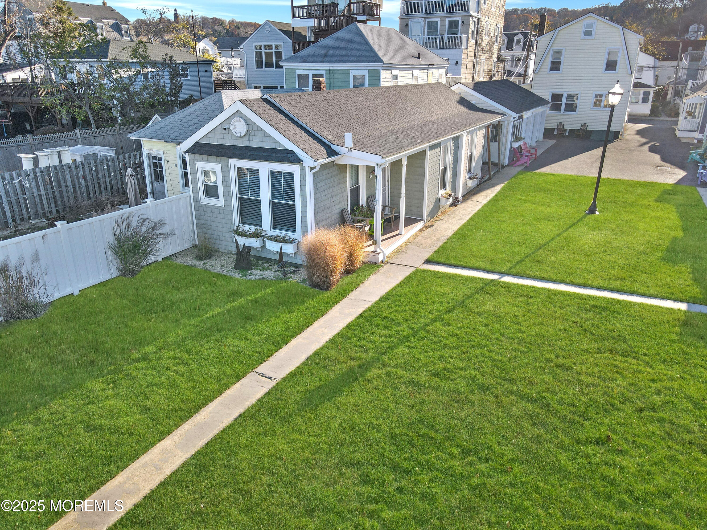 54 5th Street, Unit A Highlands, NJ 07732 - Photo 2 of 11 a aerial view of a house with a yard table and chairs