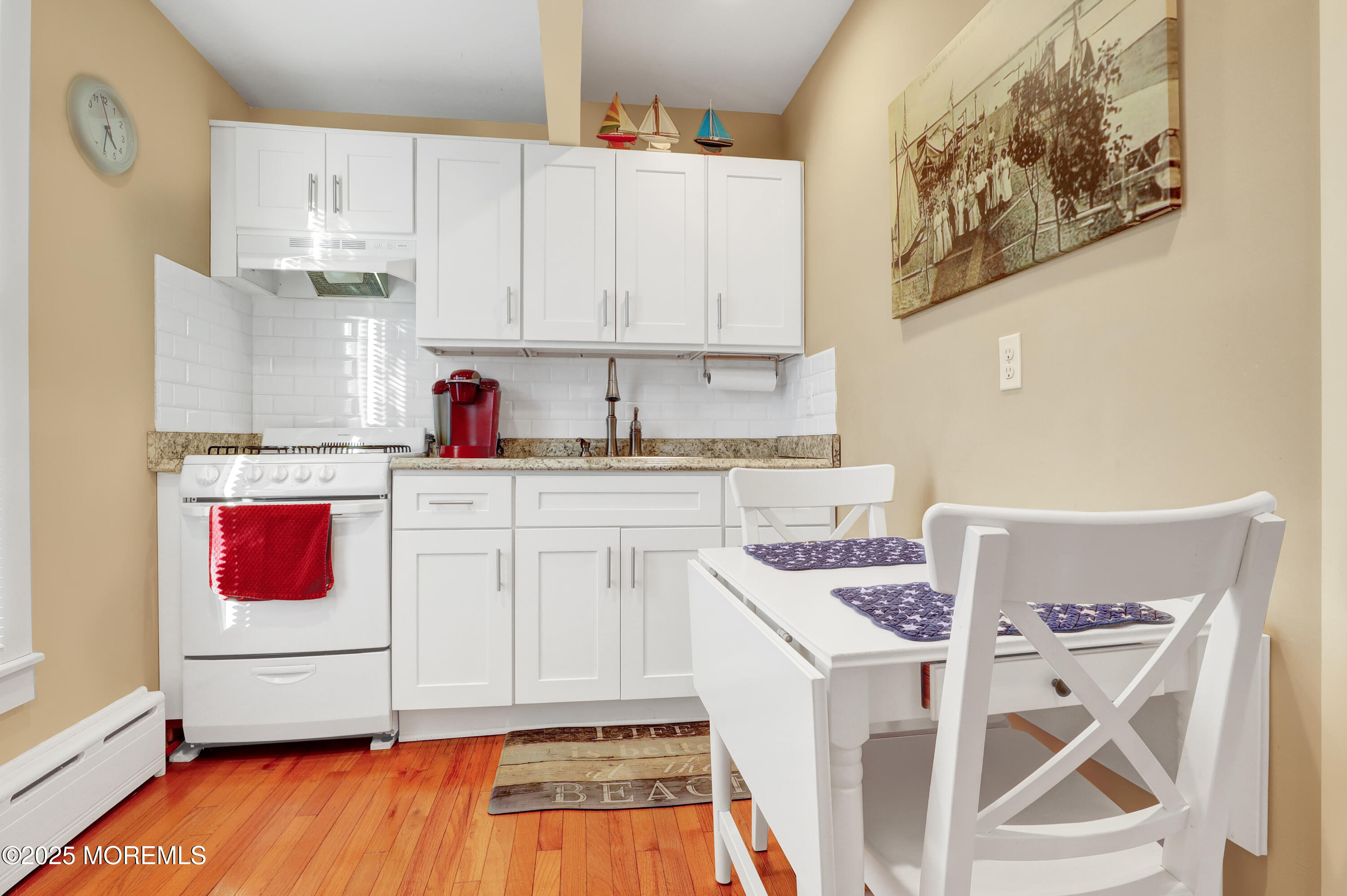 54 5th Street, Unit A Highlands, NJ 07732 - Photo 8 of 11 a kitchen with a sink stove and white cabinets