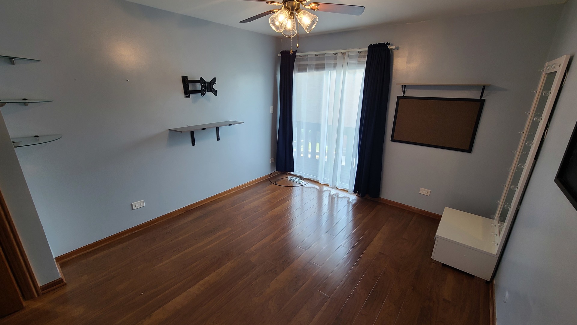 7548 Clarendon Hills Road, Unit 1B Willowbrook, IL 60527 - Photo 19 of 33 a view of an empty room with wooden floor and a window