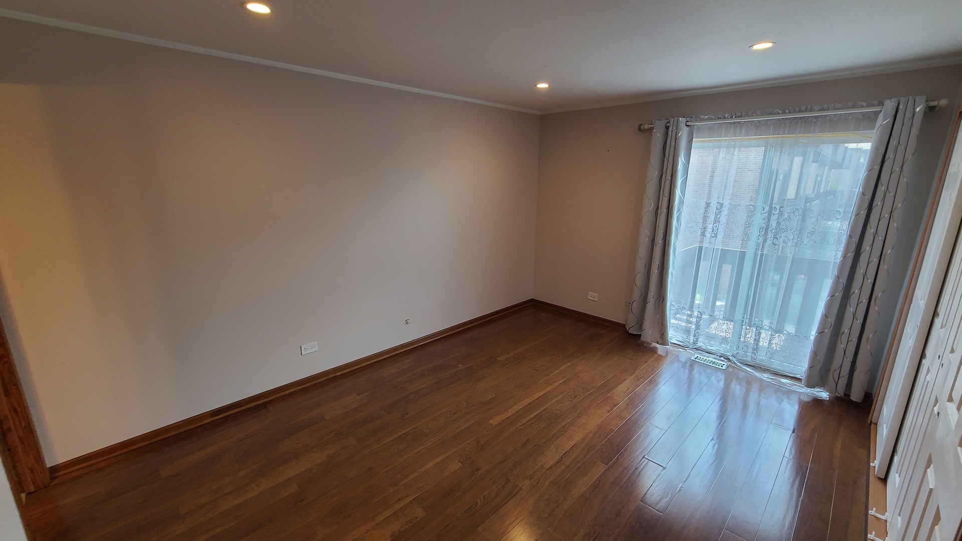 7548 Clarendon Hills Road, Unit 1B Willowbrook, IL 60527 - Photo 23 of 33 an empty room with wooden floor and door
