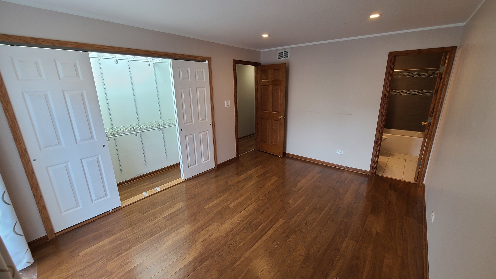 7548 Clarendon Hills Road, Unit 1B Willowbrook, IL 60527 - Photo 24 of 33 an empty room with wooden floor and closet