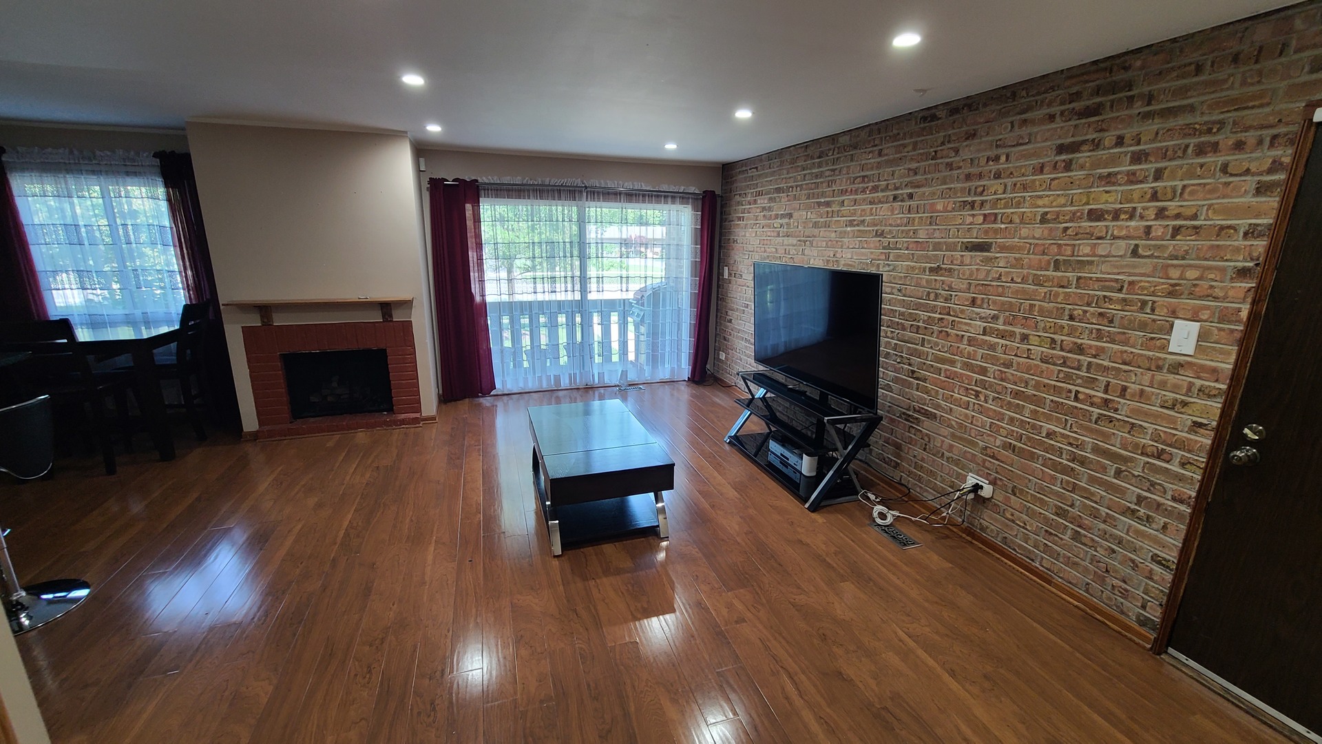 7548 Clarendon Hills Road, Unit 1B Willowbrook, IL 60527 - Photo 6 of 33 a living room with furniture and a flat screen tv