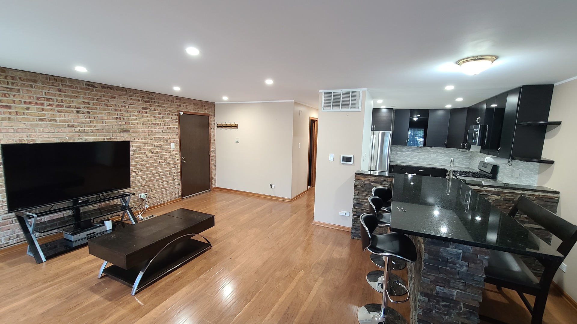 7548 Clarendon Hills Road, Unit 1B Willowbrook, IL 60527 - Photo 7 of 33 a living room with furniture a flat screen tv and a fireplace