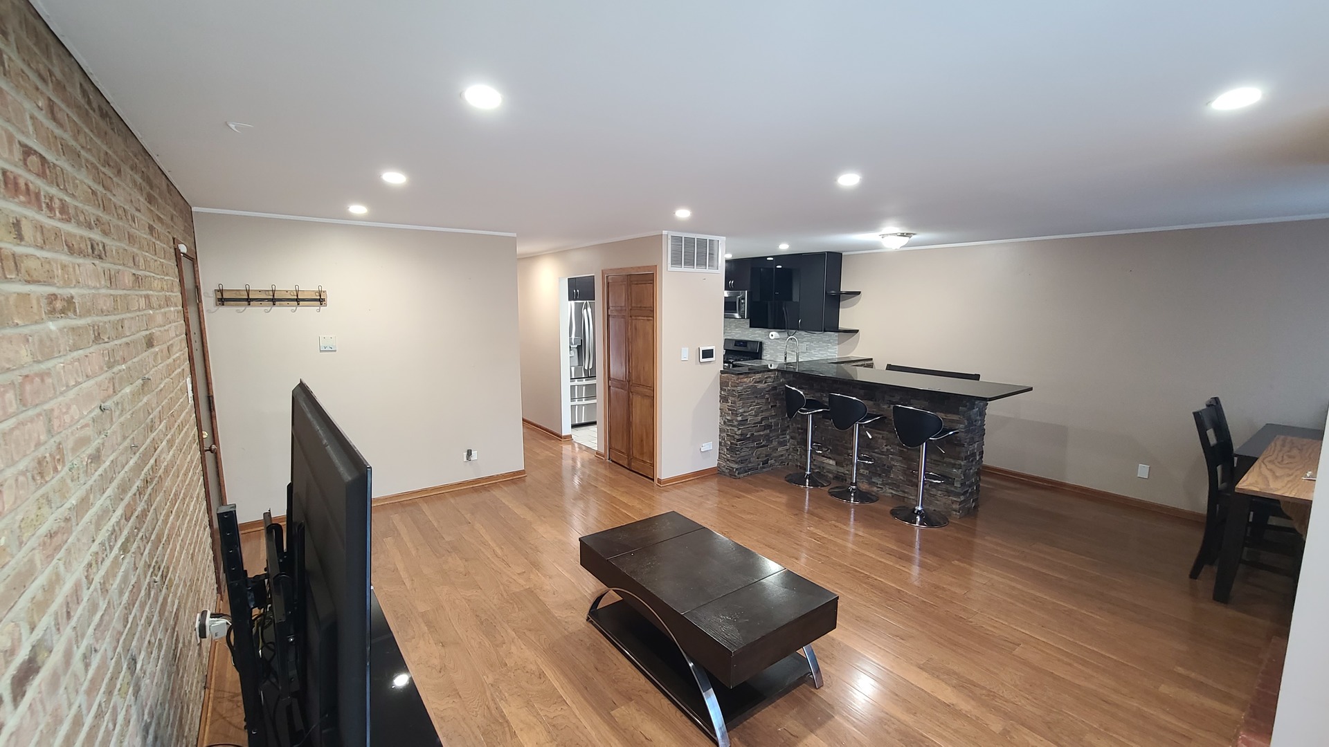 7548 Clarendon Hills Road, Unit 1B Willowbrook, IL 60527 - Photo 9 of 33 a living room with furniture and a wooden floor