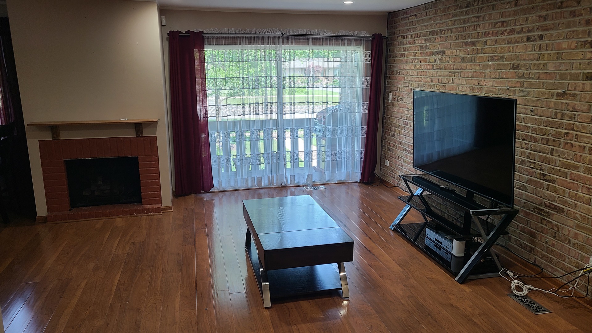 7548 Clarendon Hills Road, Unit 1B Willowbrook, IL 60527 - Photo 10 of 33 a living room with furniture and a flat screen tv