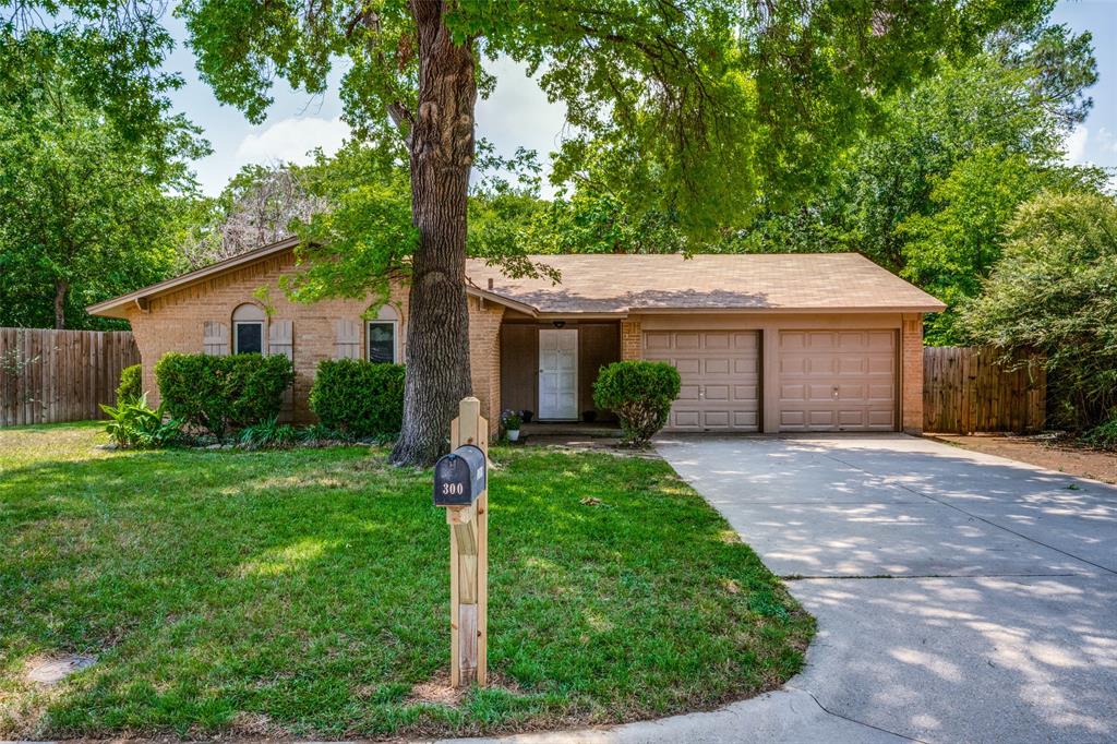 300 Bluebird Circle Denton, TX 76209 - Photo 1 of 1 a front view of a house with a yard and trees
