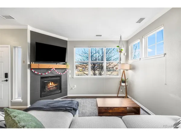 a living room with fireplace furniture and a flat screen tv