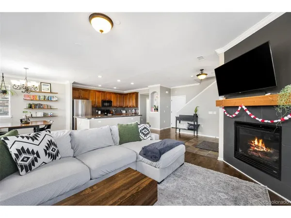 a living room with furniture a flat screen tv and a fireplace