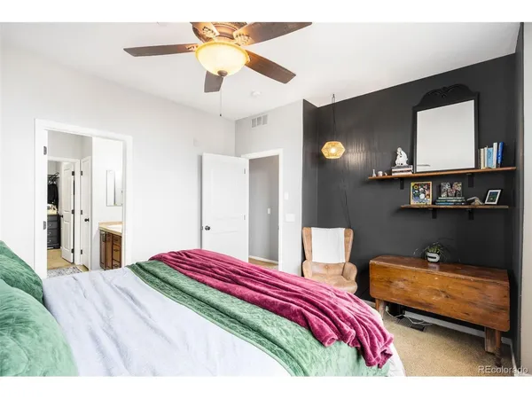 a bedroom with a bed and a mirror