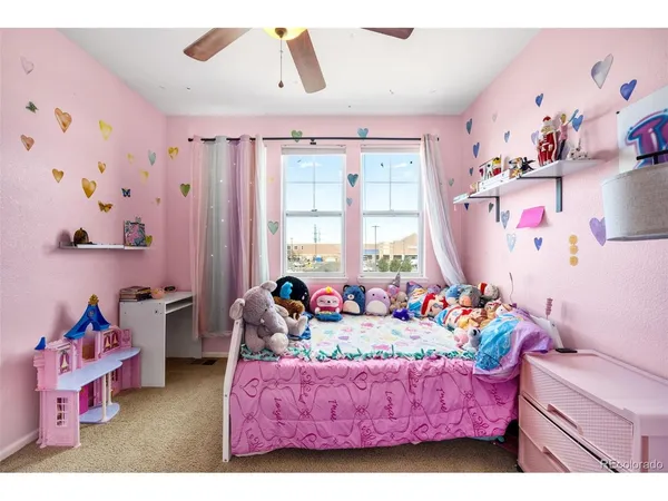a living room with furniture and a baby crib