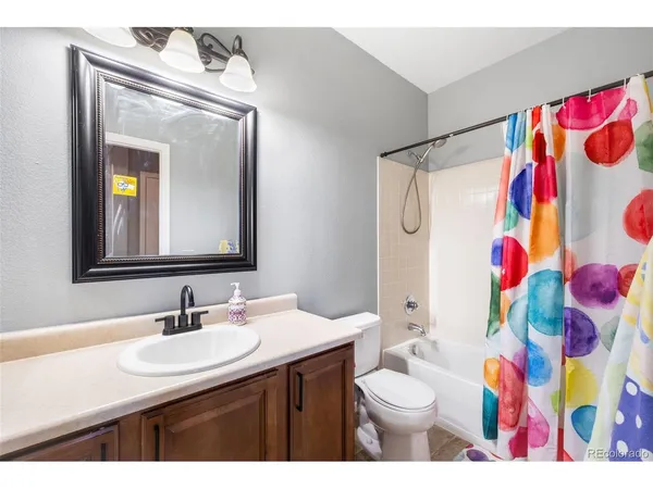 a bathroom with a sink vanity mirror and toilet