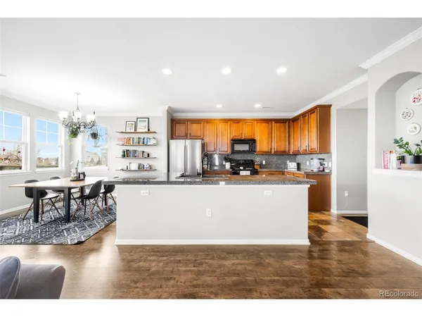 a living room with stainless steel appliances kitchen island granite countertop a living room view and living room view