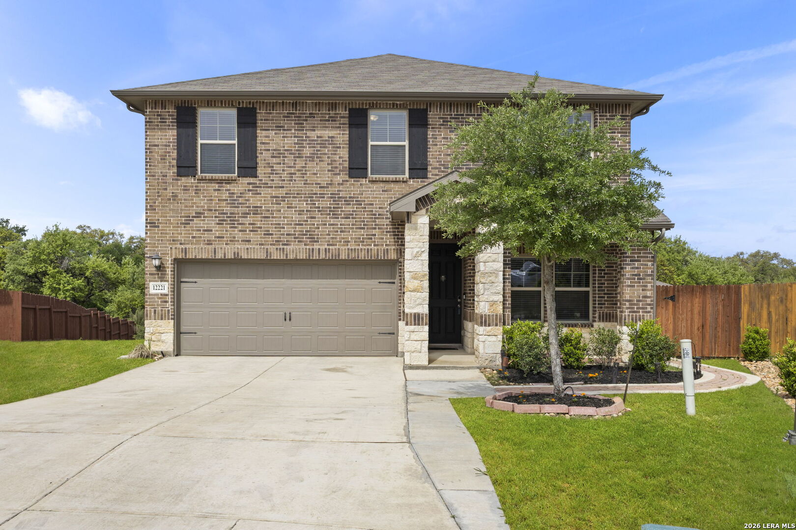 12221 Icon Ridge San Antonio, TX 78253 - Photo 2 of 46 a front view of a house with garden