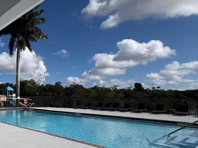 a view of swimming pool with a table and chairs