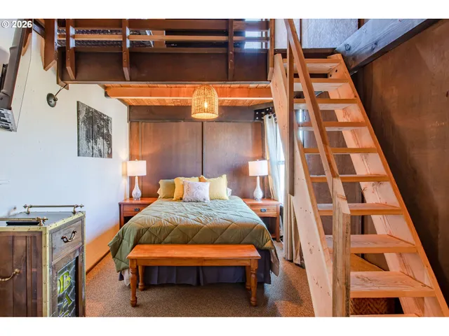 a bedroom with a bed and a night stand