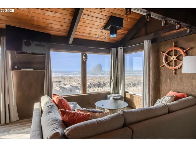 a kitchen with stainless steel appliances kitchen island granite countertop a table chairs in it and wooden floors