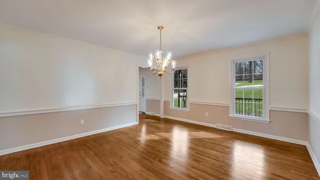 a view of a room with window and wooden floor