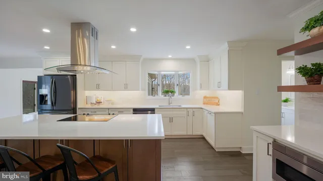 a kitchen with stainless steel appliances a sink stove and refrigerator