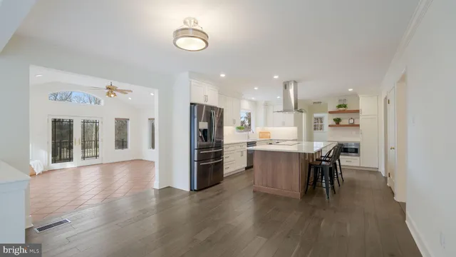a view of kitchen with refrigerator microwave and wooden floor