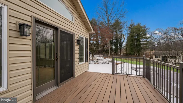 a view of a balcony with chair and wooden floor