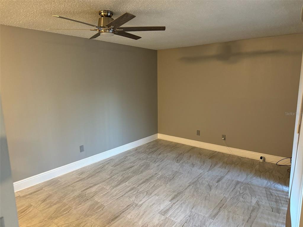 1030 Abada Court Northeast, Unit 110 Palm Bay, FL 32905 - Photo 2 of 10 a view of an empty room with a window