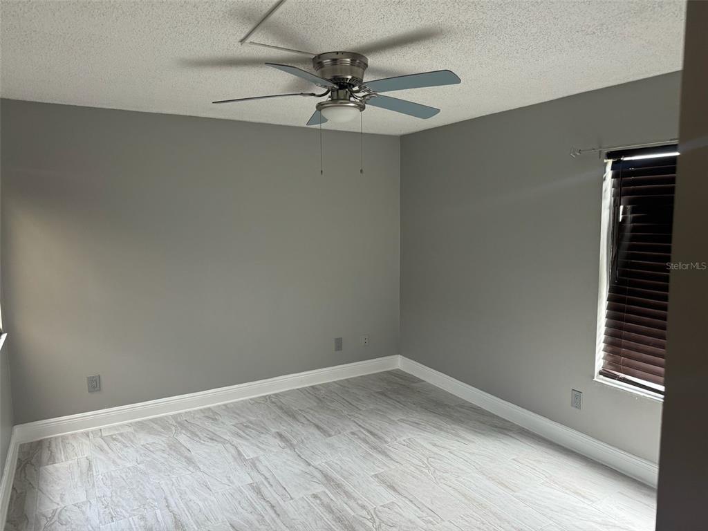 1030 Abada Court Northeast, Unit 110 Palm Bay, FL 32905 - Photo 7 of 10 a view of an empty room with a window