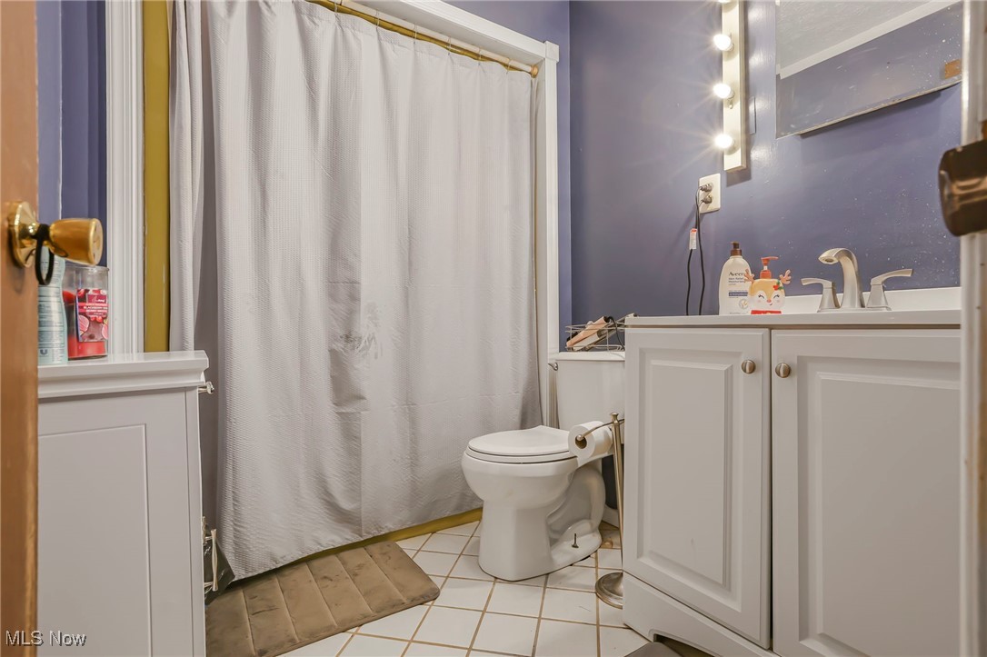 232 McGill Road Vincent, OH 45784 - Photo 18 of 49 Bathroom with vanity, a shower with curtain, and light tile patterned floors