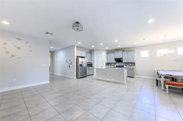 a kitchen with stainless steel appliances granite countertop a refrigerator and a stove top oven