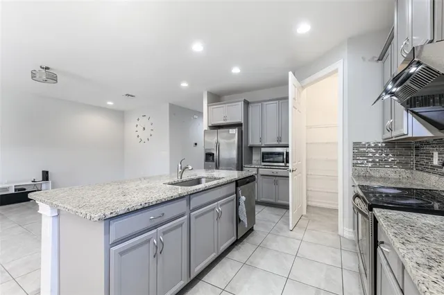 a kitchen with granite countertop stainless steel appliances and cabinets