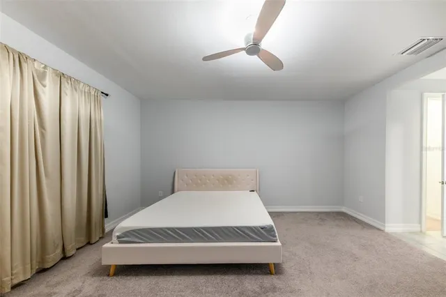 a bedroom with a bed and a night stand