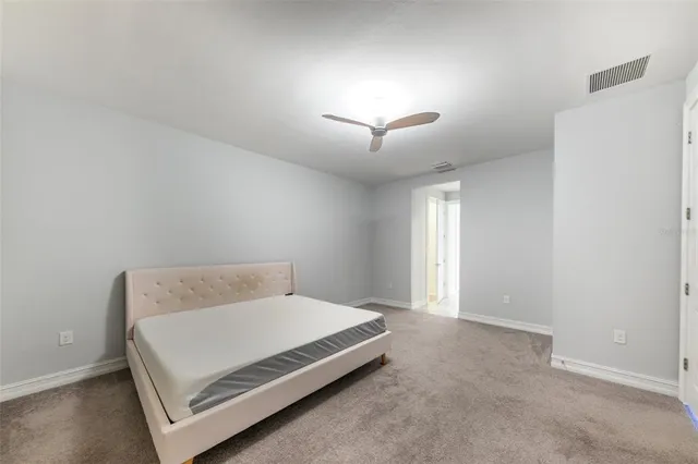 a bedroom with a bed and a lamp