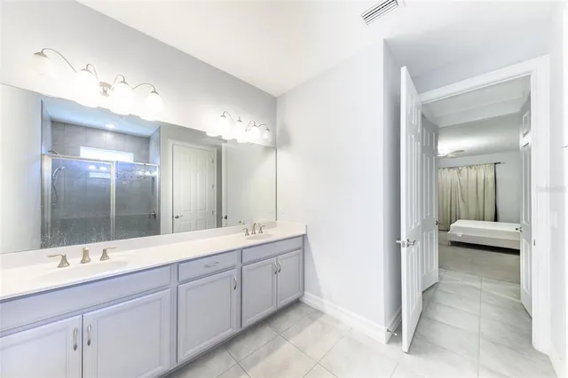 a bathroom with a glass shower door