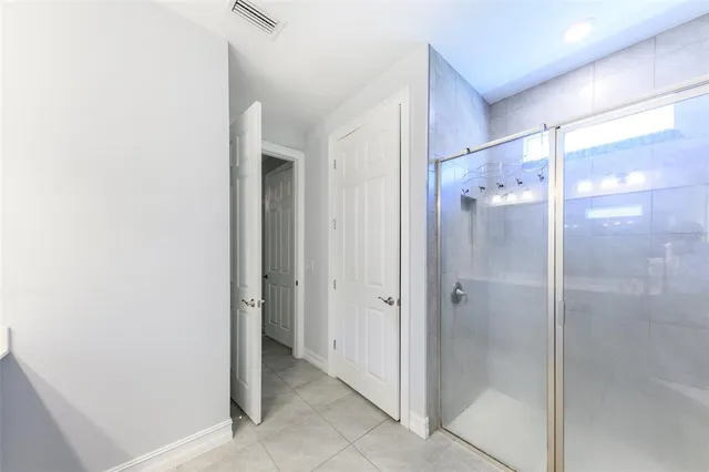 a bathroom with a glass shower door