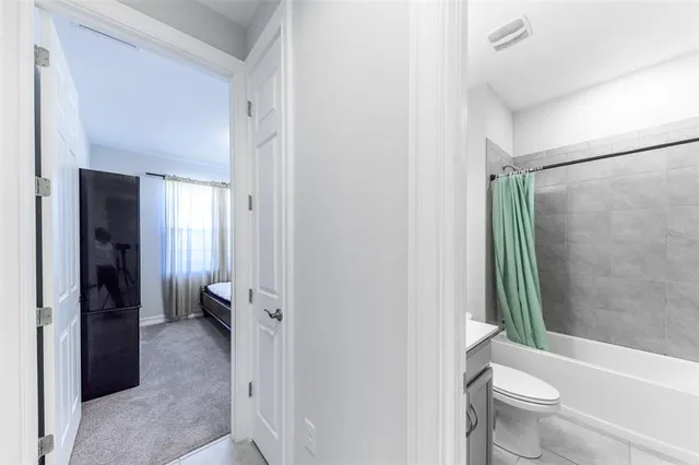 a bed sitting in a room next to a window