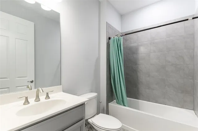 a bathroom with a sink a toilet and mirror