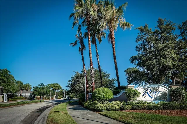 a front view of a house with plants