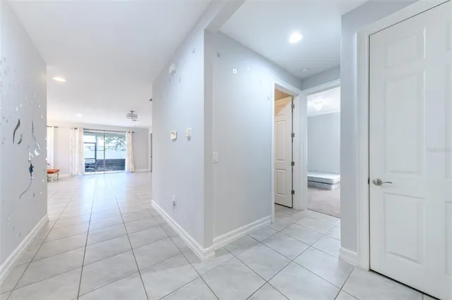 a kitchen with white cabinets and refrigerator