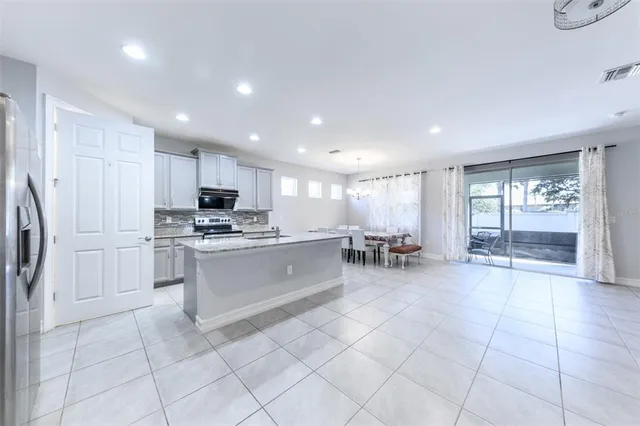 a large white kitchen with lots of counter space and a sink