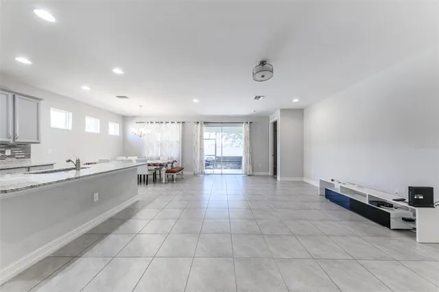 an empty room with sliding door and chandelier
