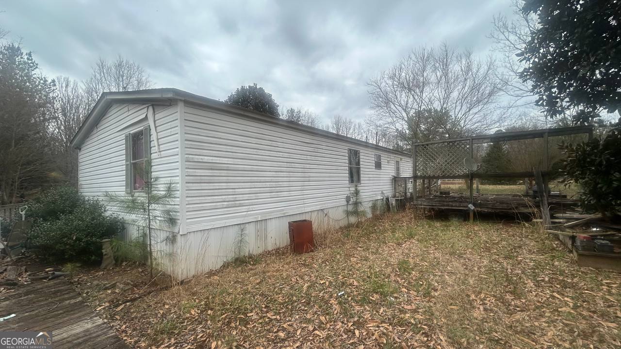 19 Kathryn Way Commerce, GA 30530 - Photo 3 of 14 a backyard of a house with barbeque oven and outdoor seating