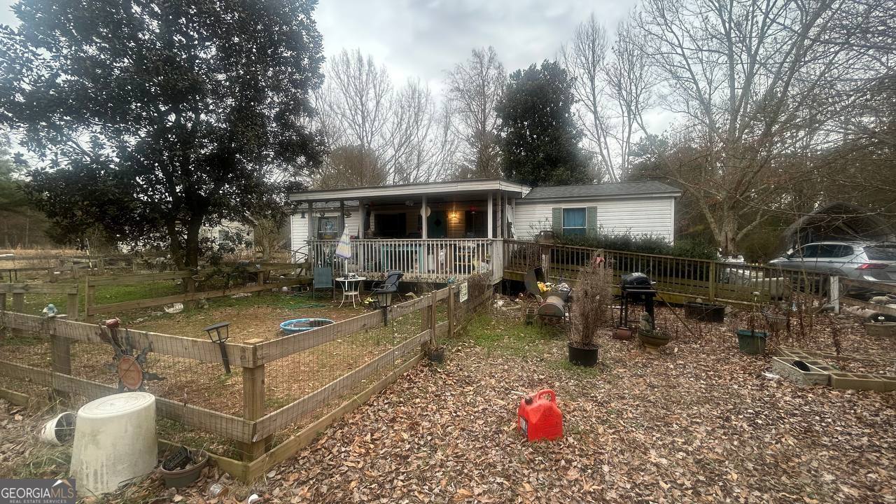19 Kathryn Way Commerce, GA 30530 - Photo 9 of 14 a backyard of a house with table and chairs