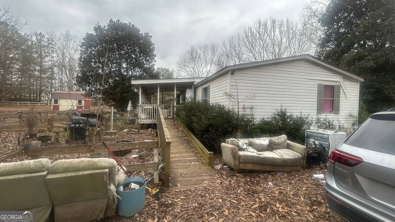 19 Kathryn Way Commerce, GA 30530 - Photo 10 of 14 a view of a patio with couches table and chairs and potted plants