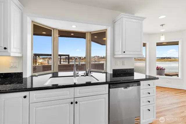 a kitchen with granite countertop a stove a sink and a granite counter tops