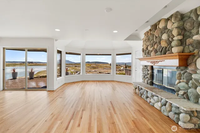 wooden floor in an empty room with a fireplace