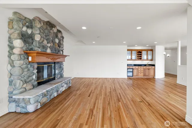 a view of a living room a wooden floor and a fireplace