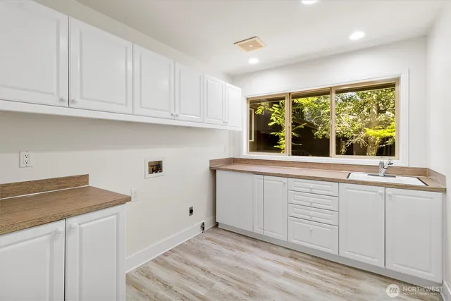 a kitchen with granite countertop white cabinets and a window