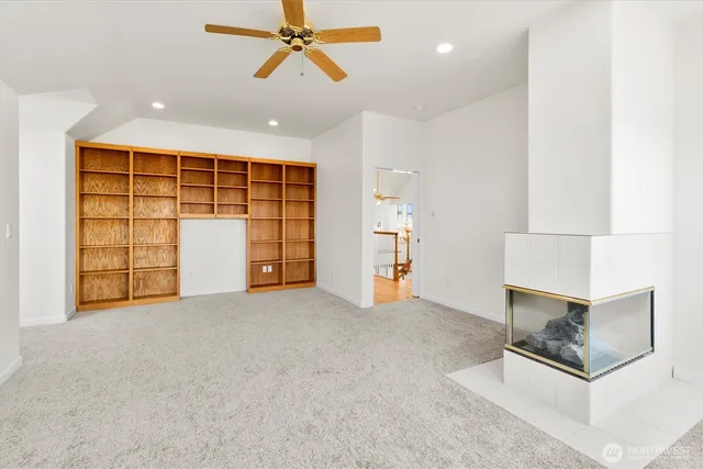 an empty room with windows and cabinet