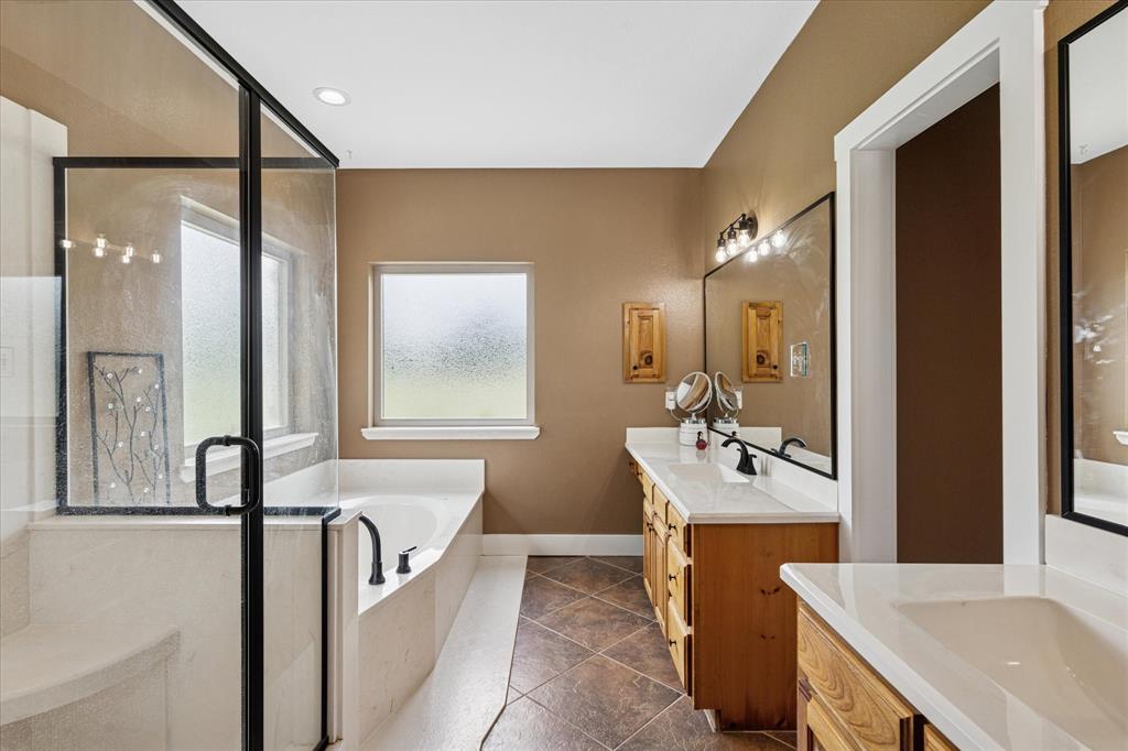 6251 Hayes Road Midlothian, TX 76065 - Photo 17 of 30 a spacious bathroom with a bathtub sink and mirror