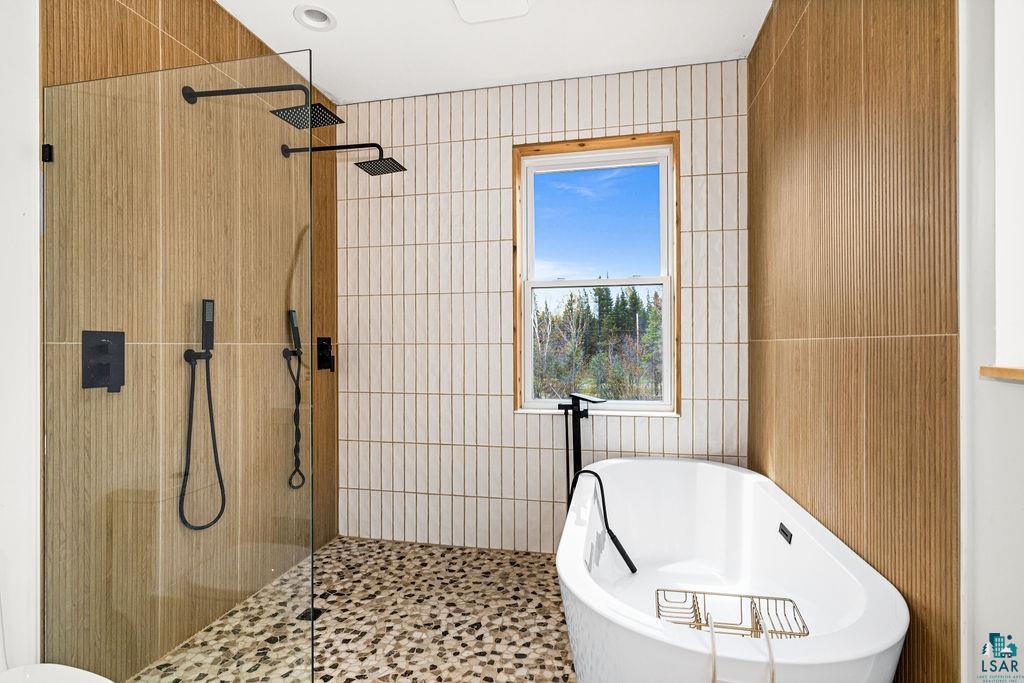 1825 East Shilhon Road Duluth, MN 55804 - Photo 26 of 37 Therapeutic freestanding soaking tub and glass-enclosed shower with dual showers & double sink vanity.