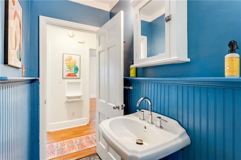 2083 West Rugby Avenue College Park, GA 30337 - Photo 21 of 49 a bathroom with a sink a mirror and a shower